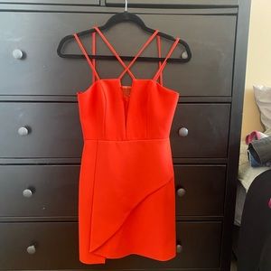 Coral BCBG mini dress. Sheer design on v neck, criss cross straps. Size 0